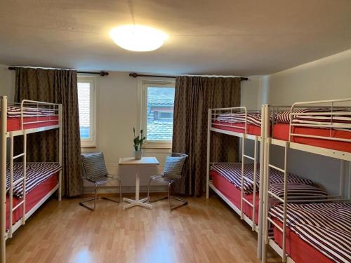 Dorm with bunk beds and large windows