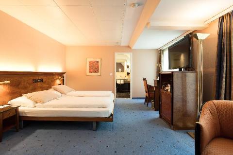 Where To Stay In Zurich, Switzerland: BEST Hotels in 2025 15 Double room with wood decor and carpet