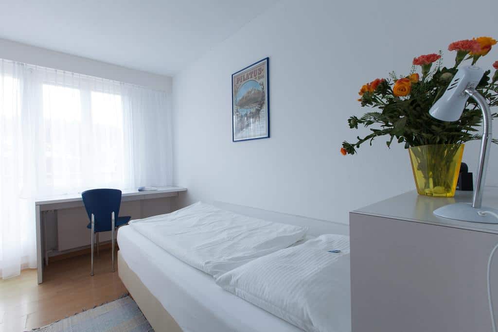 Simple hotel room with single bed and small desk