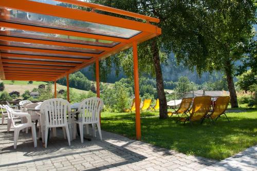 20 BEST Things To Do In Lauterbrunnen (2025 GUIDE) 37 Outdoor seating and sun loungers under trees with views of the hills.