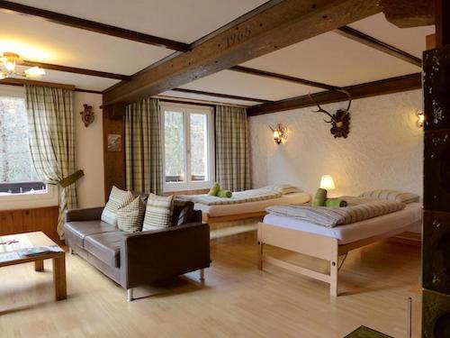 Rustic alpine room with twin beds and wood beams