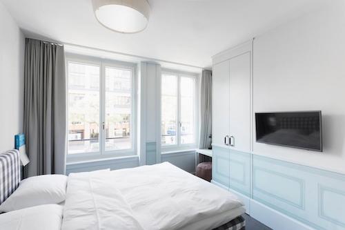 Bright hotel room with blue accents and large window