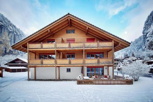 Wooden Swiss chalet surrounded by snow in the Alps