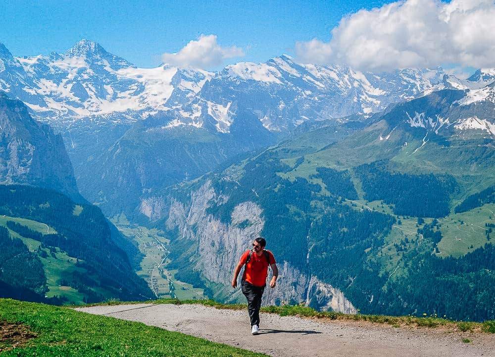 Man hiking with Alps in the background