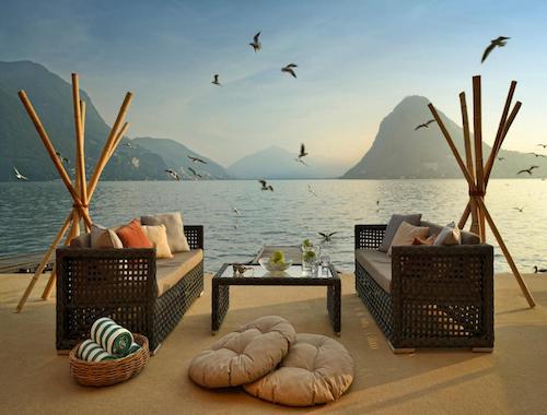 Lakeside seating area with mountain views and wicker furniture