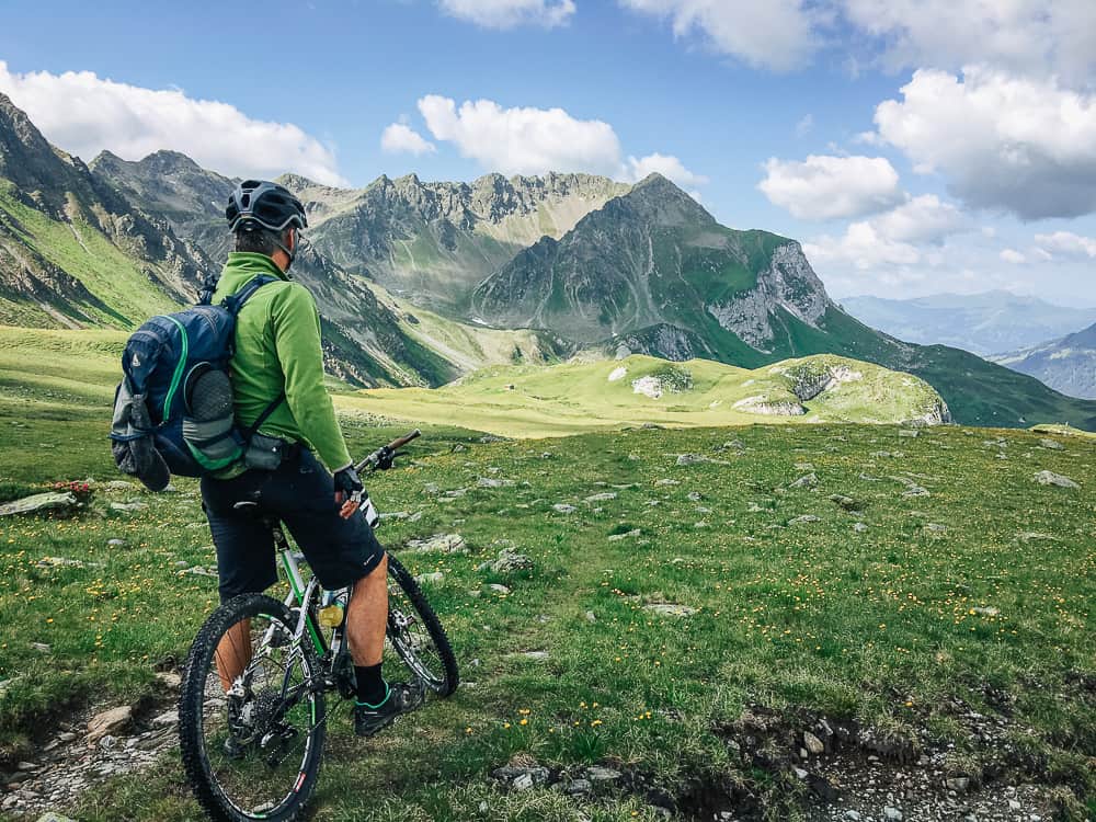 Cyclist overlooking the Swiss mountains
