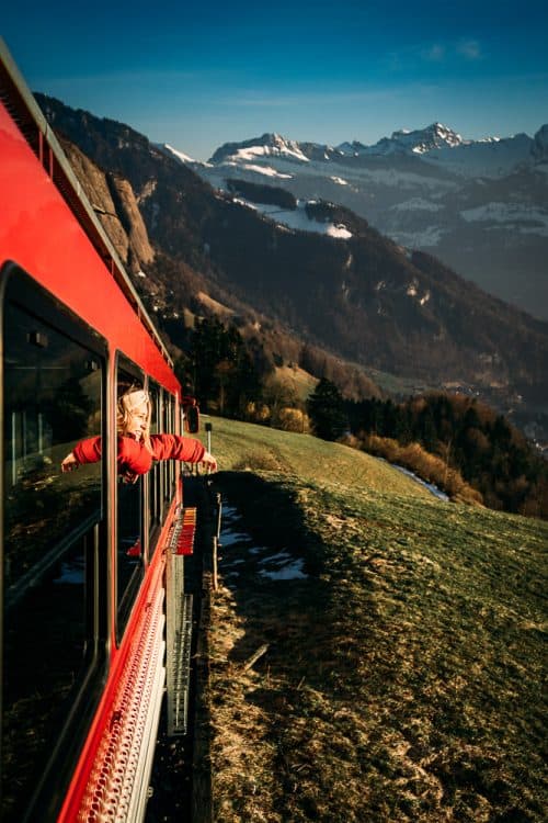 The BEST 8 Day Switzerland Itinerary For First-Timers (2025) 10 Red cogwheel train climbing through Swiss mountain landscape