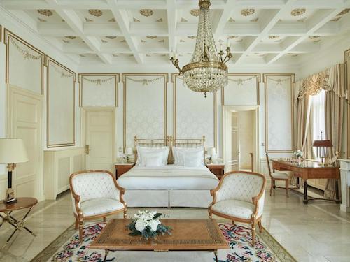 Elegant luxury suite with chandelier and classic furniture.