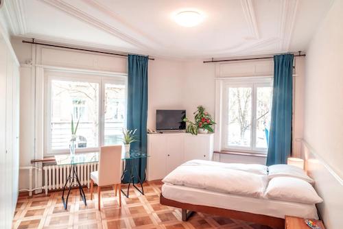 Minimalist budget hotel room with natural light.