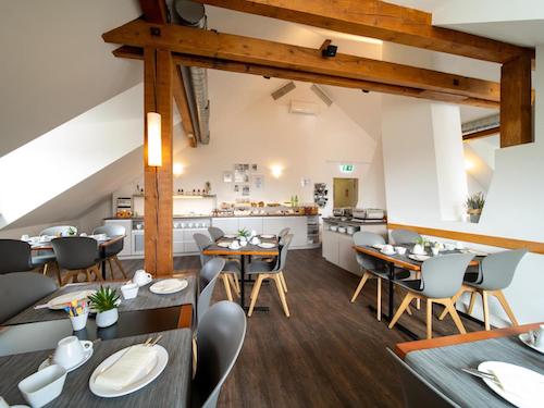 Cozy breakfast room with wooden beams and a buffet in the corner