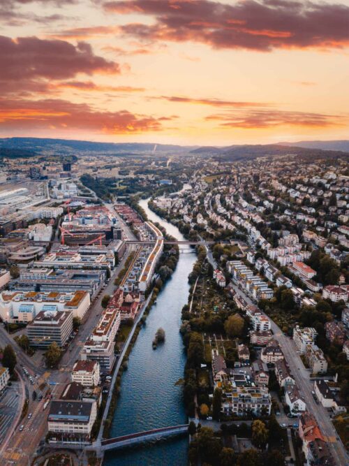 Sunset over Zurich city and winding river.